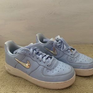 Light blue Nike Air Force 1s.